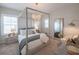 Serene main bedroom with a four-poster bed, chandelier, and ample natural light at 11571 Gleaming Ter, Venice, FL 34293