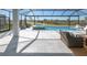 Screened-in lanai with a pool, spa, and outdoor seating area at 11571 Gleaming Ter, Venice, FL 34293