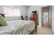 Bedroom with a wood bed frame, dresser, and a view of the hallway in a light and airy space at 1282 Reserve Dr, Venice, FL 34285