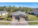 A tranquil community showcasing houses with brick driveways, mature trees, and lush lawns at 13542 Abercrombie Dr, Englewood, FL 34223