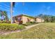A charming home with a well-manicured lawn, lush landscaping, and a quaint walkway, with a prominent American flag display at 13542 Abercrombie Dr, Englewood, FL 34223