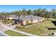 Beautiful property featuring lush lawn, mature trees, complemented by brick driveway, and American flag at 13542 Abercrombie Dr, Englewood, FL 34223