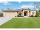 Charming single-story home boasts a manicured lawn, attached two car garage, and lovely landscaping at 1684 Ruiz St, North Port, FL 34286