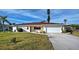 Charming single-story home features a well-maintained lawn and a two-car garage at 1723 N Gondola Ct, Venice, FL 34293