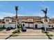 Spacious condos with terracotta tile roofs and paved driveways, perfect for relaxed community living with tropical landscaping at 23108 Banbury Way # 202, Venice, FL 34293