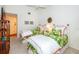 Bright bedroom featuring twin beds with tropical patterned bedding and a ceiling fan at 237 Southampton Ln # 275, Venice, FL 34293