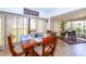 Dining area featuring a wood table, neutral chairs, and views of the backyard at 237 Southampton Ln # 275, Venice, FL 34293