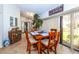 Inviting dining room with wood table set for four and sliding door to the backyard at 237 Southampton Ln # 275, Venice, FL 34293