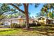 Charming single-story home featuring mature trees, lush landscaping, and a two-car garage at 237 Southampton Ln # 275, Venice, FL 34293