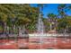 Community water fountain surrounded by lush trees and benches, perfect for a relaxing stroll at 237 Southampton Ln # 275, Venice, FL 34293