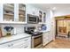 Modern kitchen with stainless steel appliances, white cabinetry, and a subway tile backsplash at 237 Southampton Ln # 275, Venice, FL 34293