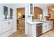 Spacious kitchen featuring white cabinetry and views into the living room at 237 Southampton Ln # 275, Venice, FL 34293