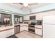 Bright kitchen features white cabinets, stainless steel appliances, and a double oven for easy cooking at 237 Southampton Ln # 275, Venice, FL 34293