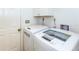 Convenient laundry room featuring modern washer and dryer units and ample storage at 237 Southampton Ln # 275, Venice, FL 34293