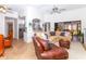 Open-concept living room featuring tile floors, a ceiling fan, and views into the kitchen at 237 Southampton Ln # 275, Venice, FL 34293
