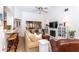 Bright living room with a fireplace, ceiling fan, and views to the kitchen and dining area at 237 Southampton Ln # 275, Venice, FL 34293