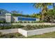 Community sign for Myrtle Trace, framed by manicured landscaping and palm trees at 237 Southampton Ln # 275, Venice, FL 34293
