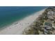 Overhead shot of a sandy beach featuring beachgoers, and a range of facilities on the coastline at 2737 Cottage Ln, North Port, FL 34286