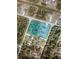 Aerial view showcases a landscaped property with a pool, nestled among lush greenery in a neighborhood at 2737 Cottage Ln, North Port, FL 34286
