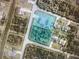 Aerial view of a property with a pool, surrounded by greenery in a residential neighborhood at 2737 Cottage Ln, North Port, FL 34286