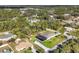 High aerial shot of a residential area with houses, lawns, driveways, and many leafy trees, plus a screened pool at 2737 Cottage Ln, North Port, FL 34286