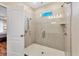 Updated bathroom featuring tiled glass shower with window and handheld shower fixture at 2737 Cottage Ln, North Port, FL 34286