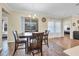 Bright dining area with wood-look floors and sliding glass doors to the lanai at 2737 Cottage Ln, North Port, FL 34286
