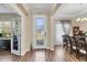 Elegant foyer featuring a decorative glass front door, wood-look floors, and a view of the dining area at 2737 Cottage Ln, North Port, FL 34286