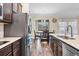 Well-equipped kitchen featuring stainless steel appliances, dark wood cabinets, and tile flooring at 2737 Cottage Ln, North Port, FL 34286