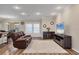Cozy living room with wood-look flooring, neutral walls, and ample natural light at 2737 Cottage Ln, North Port, FL 34286