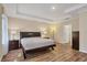 Serene main bedroom with tray ceilings, wood-look floors, and neutral paint at 2737 Cottage Ln, North Port, FL 34286