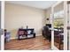 Home office featuring wood flooring, a glass paned door, and ample lighting at 2737 Cottage Ln, North Port, FL 34286