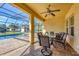 Screened-in pool area with a ceiling fan and outdoor seating for entertaining at 2737 Cottage Ln, North Port, FL 34286