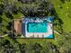 Aerial view of a community pool and surrounding greenery in a well-maintained area at 4619 Forest Wood Trl # 7, Sarasota, FL 34241