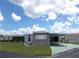 Charming single-story home with carport and green lawn under a partly cloudy sky at 476 Boxwood Dr, Venice, FL 34285