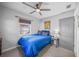 Calm bedroom featuring a blue bedspread, neutral walls, carpet, and a modern ceiling fan with light at 6204 Deming Ave, North Port, FL 34287