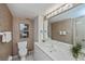 Bathroom with a white sink, toilet, storage cabinet, and a mirror at 627 Alhambra Rd # 601, Venice, FL 34285