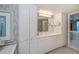 Bathroom vanity with white cabinets, large mirror, and modern lighting at 627 Alhambra Rd # 601, Venice, FL 34285