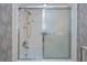 Bathroom shower with white tile, sliding glass door, and silver fixtures at 627 Alhambra Rd # 601, Venice, FL 34285