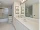 Bathroom with white vanity, large mirror, and shower at 627 Alhambra Rd # 601, Venice, FL 34285