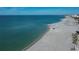 Beautiful waterfront view of the beach with clear blue ocean waters and light sandy shore at 627 Alhambra Rd # 601, Venice, FL 34285