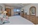 Bright bedroom featuring patio access, and wicker dressers at 627 Alhambra Rd # 601, Venice, FL 34285