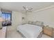 Cozy bedroom with a ceiling fan, artwork, and a window view at 627 Alhambra Rd # 601, Venice, FL 34285