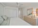 Bright bedroom with a ceiling fan, closet and dresser at 627 Alhambra Rd # 601, Venice, FL 34285