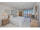Cozy bedroom with ceiling fan, patio access, and wicker furniture at 627 Alhambra Rd # 601, Venice, FL 34285