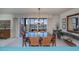 Bright dining room with large glass windows, chandelier, table and seating for six in front of outdoor balcony at 627 Alhambra Rd # 601, Venice, FL 34285