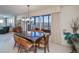 Inviting dining room with large windows, chandelier and view of the living room at 627 Alhambra Rd # 601, Venice, FL 34285