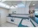 Bright kitchen features white cabinets, countertops, microwave and electric range at 627 Alhambra Rd # 601, Venice, FL 34285