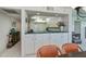 Bright kitchen features white cabinets, microwave, and open view at 627 Alhambra Rd # 601, Venice, FL 34285