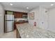 Well-equipped kitchenette with granite countertops, stainless steel appliances, and modern cabinetry at 627 Alhambra Rd # 601, Venice, FL 34285